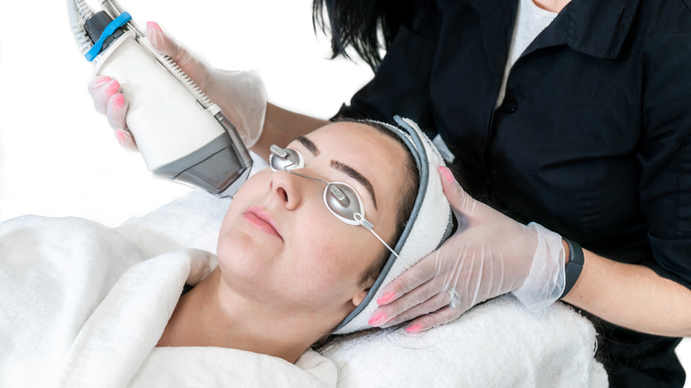 woman getting laser treatment on face