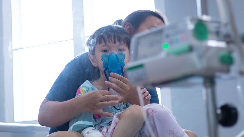 Child with nebulizer in hospital