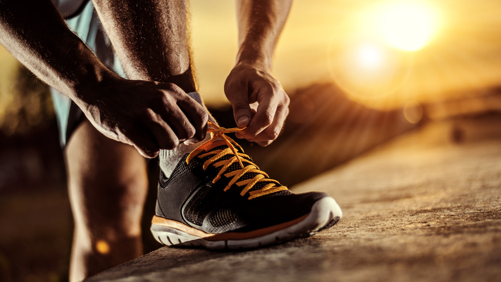 Man tying running shoes