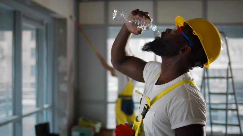 Construction worker drinking water