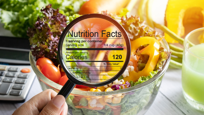 Magnified nutrition label over salad bowl