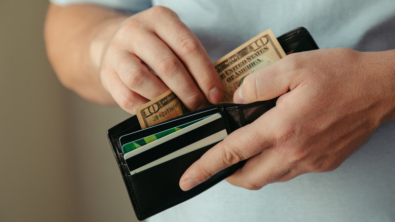 Man taking money out of his wallet