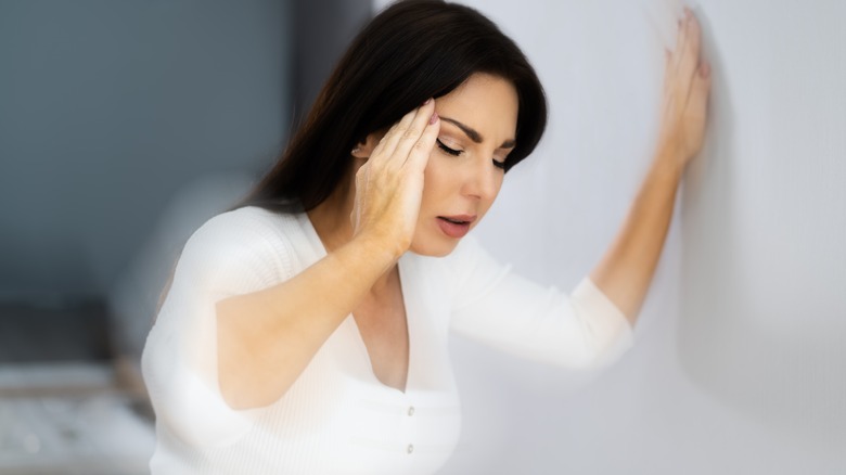 woman feeling dizzy and nauseous