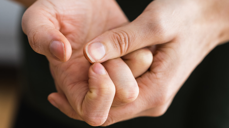 Person cracking their finger joints