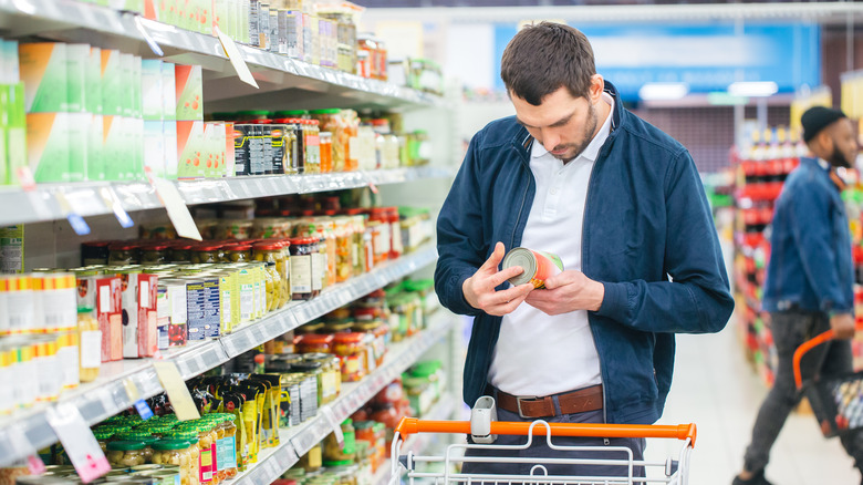 man looking at nutrition labels