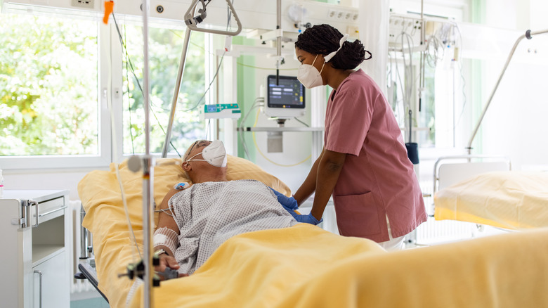 patient in ICU with nurse attending