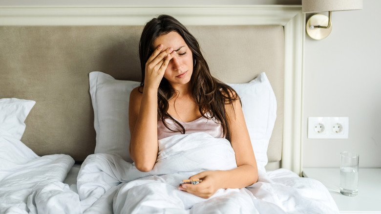 Woman in bed with headache