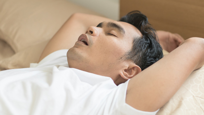 Man sleeping with sleep apnea