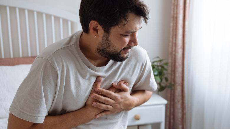 Man with chest pains in bed