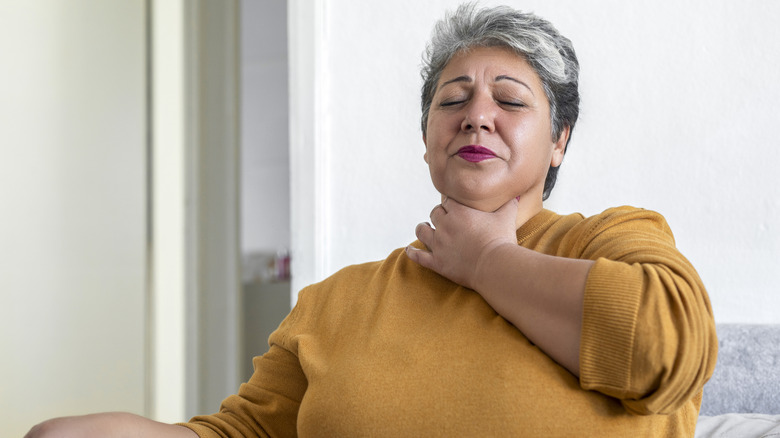 Woman sitting up and choking 