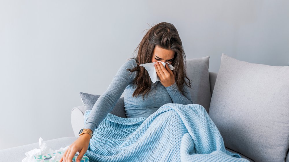 woman sick on couch