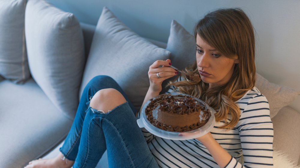 woman eating cake in bed