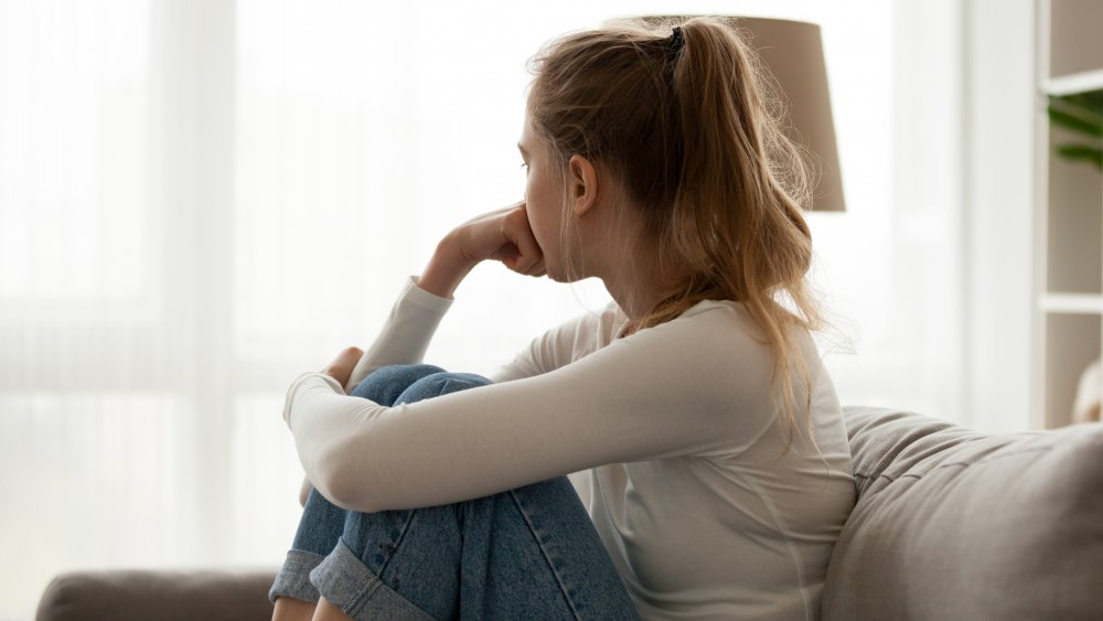 woman thinking on couch