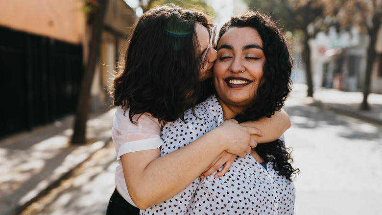 happy gay couple kissing on cheek