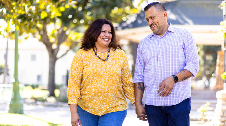 happy couple holding hands and smiling