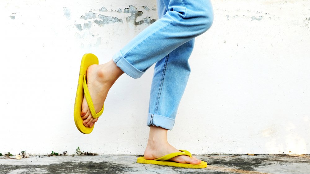 woman wearing yellow flip-flops