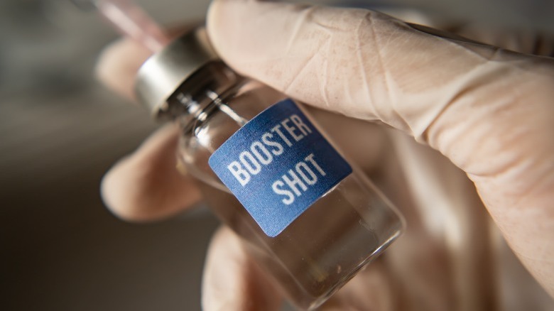booster shot dose in hand