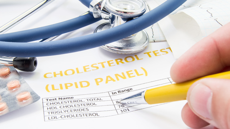 medical professional pointing to cholesterol results