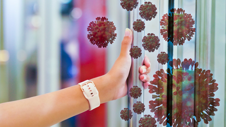 close-up of a hand on an infected door