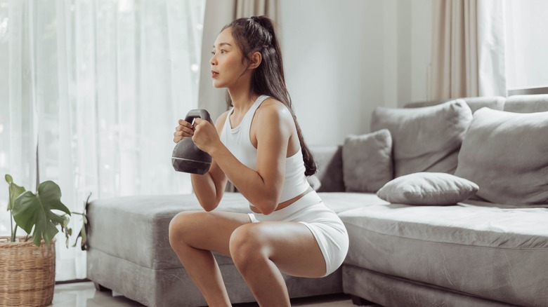 Woman squatting with a kettlebell 