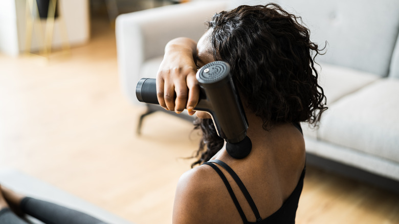 Woman using massage gun