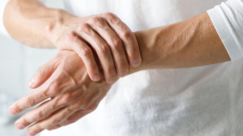 A person holding their wrist