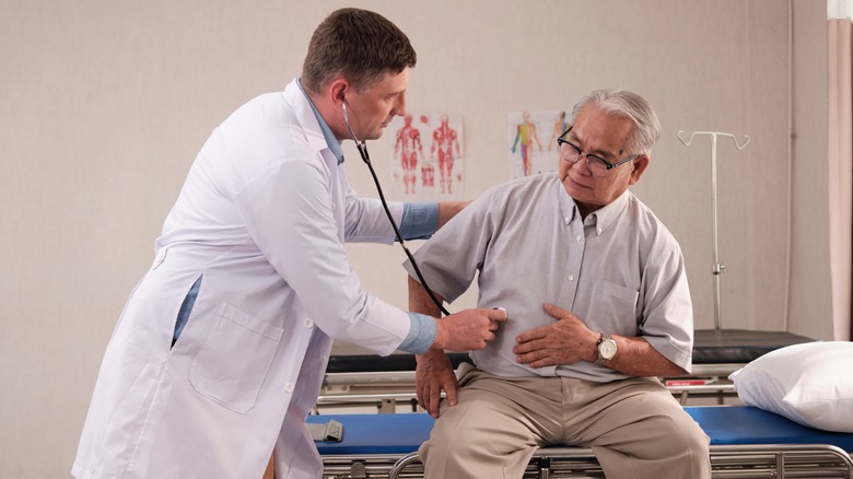 Doctor examining patient with stethoscope