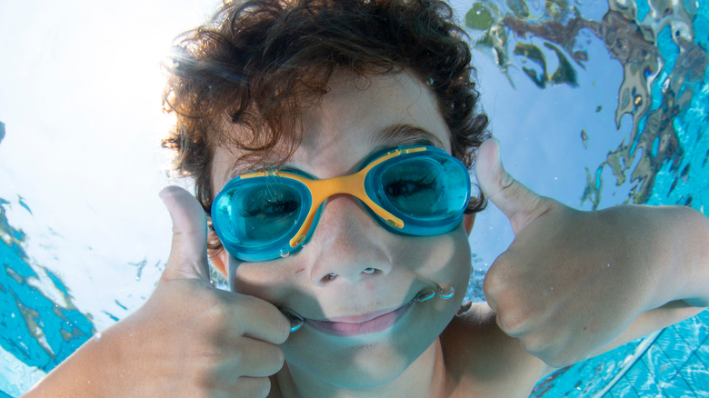 A child wearing swim goggles