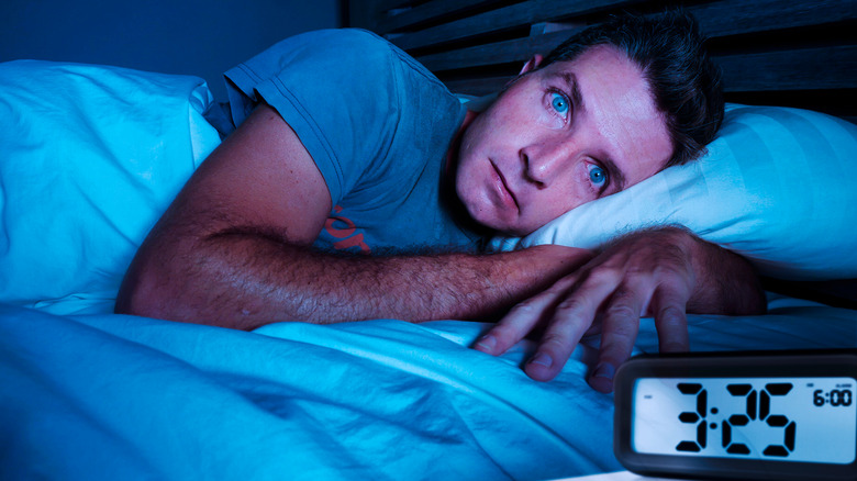 Man experiencing insomnia in bed