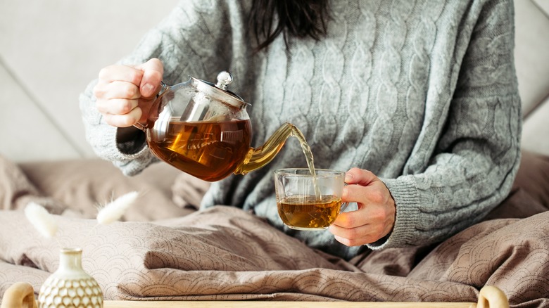 Woman having tea in bed