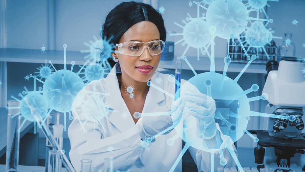 Scientist wearing protective glasses testing COVID vaccine