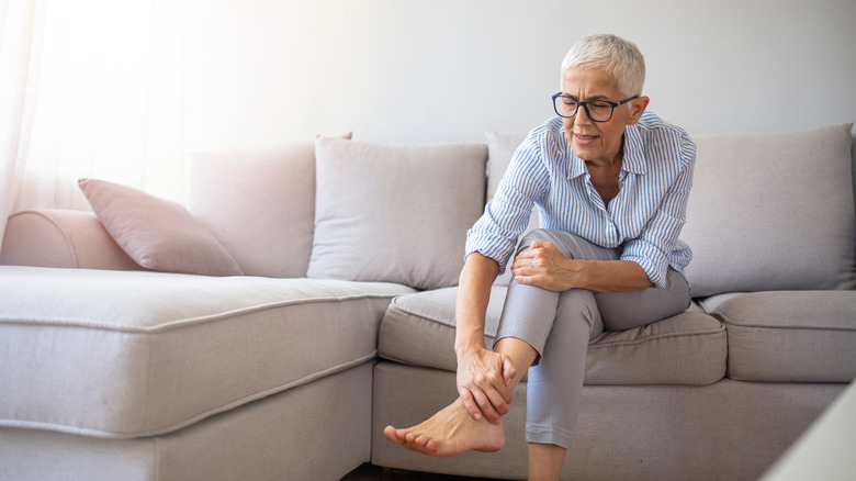 woman holding feet