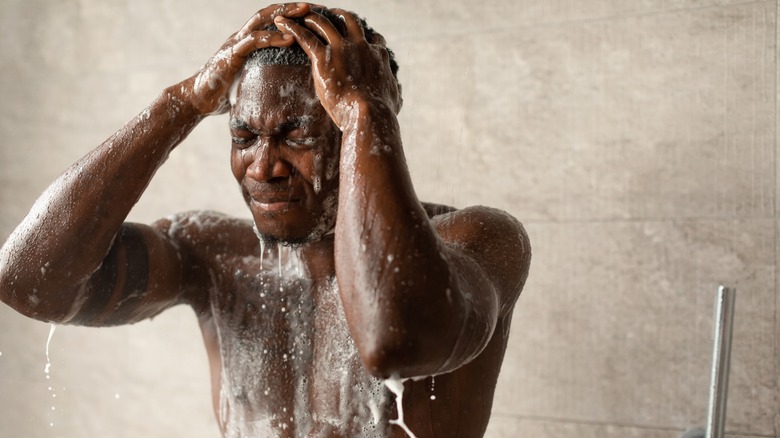 Man showering with eyes closed