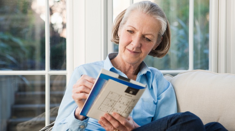 Woman doing sudoku puzzle