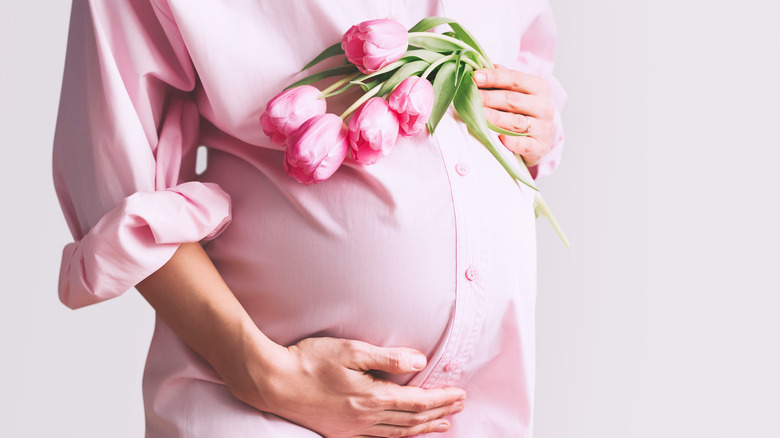 Pregnant woman's belly with flowers