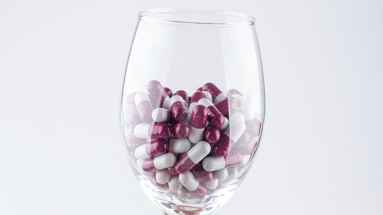 pills in wine glass