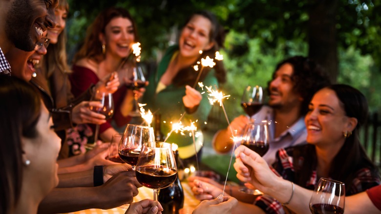 group of people drinking red wine