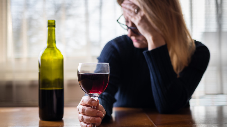 sad woman drinking wine