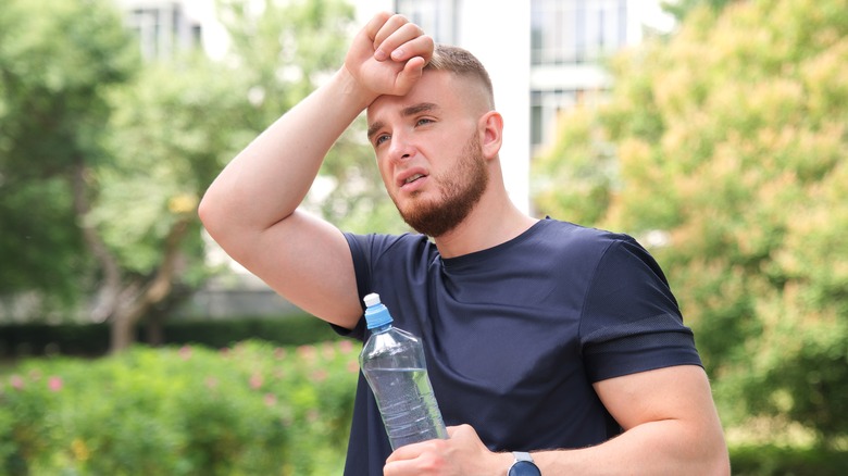 Man touching his forehead with his hand