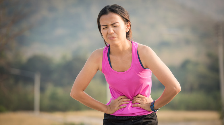 Woman having stomach pain while running