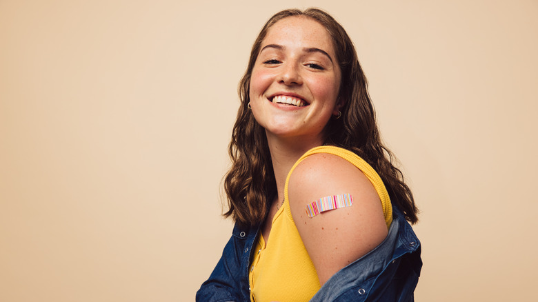 A woman smiles after getting vaccinated