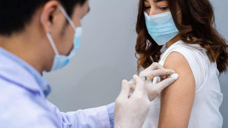 A woman receives a vaccine