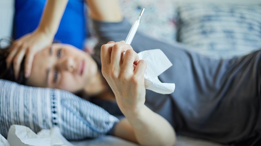 Woman holding a thermometer 