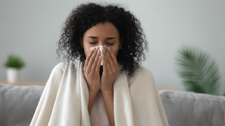 woman blowing nose