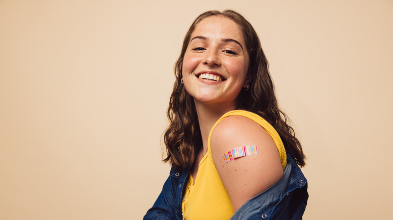 A woman smiles after getting vaccinated