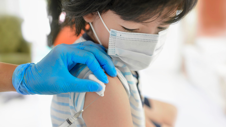 A girl gets a COVID vaccine