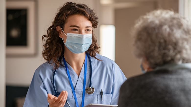 A doctor wears a mask during a visit