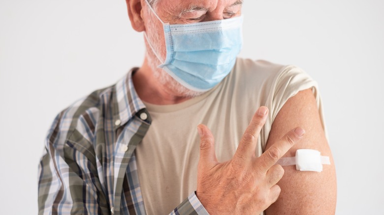 A man receives his COVID booster shot