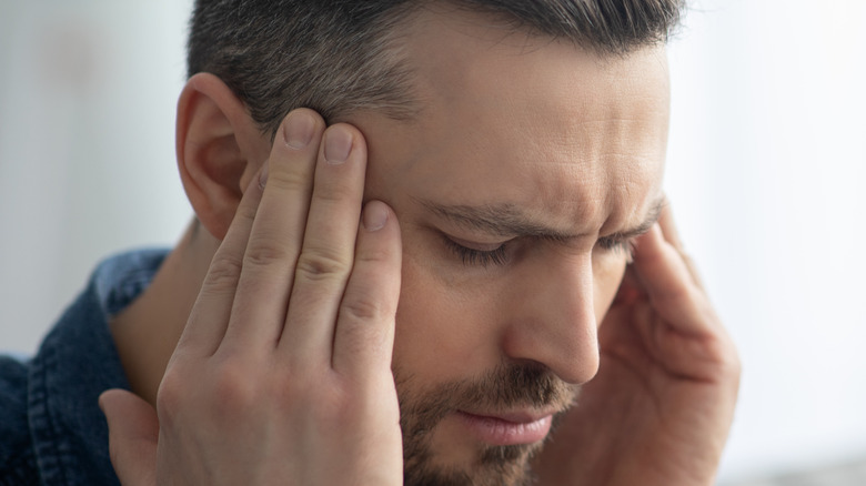 Man with headache at home