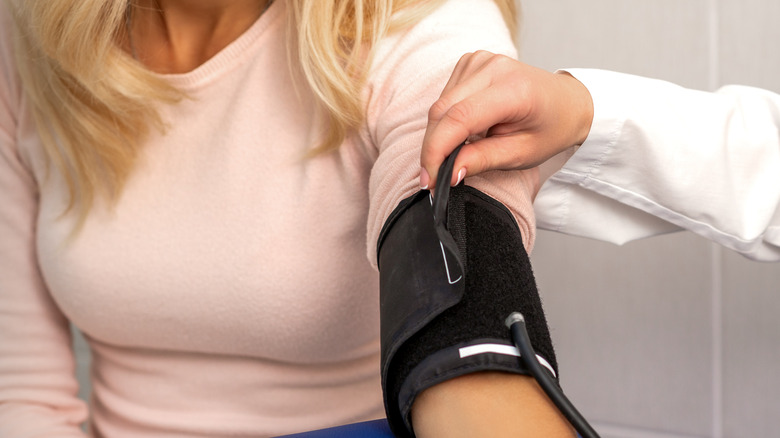 blood pressure cuff on a woman's arm